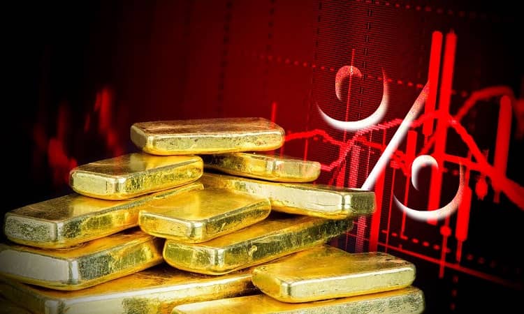 precio del oro cae, tasas de interés suben